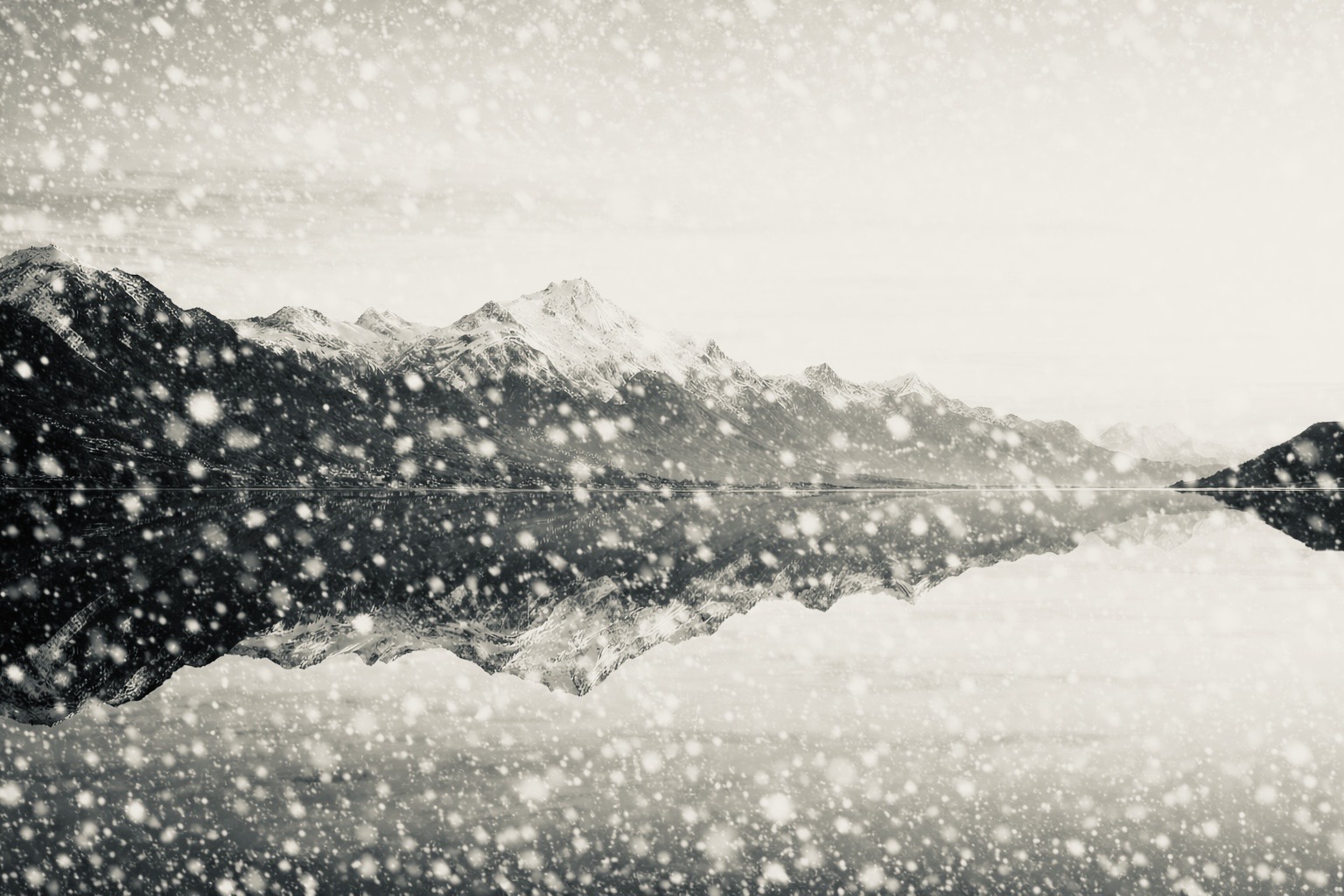 Snow over a lake and mountains